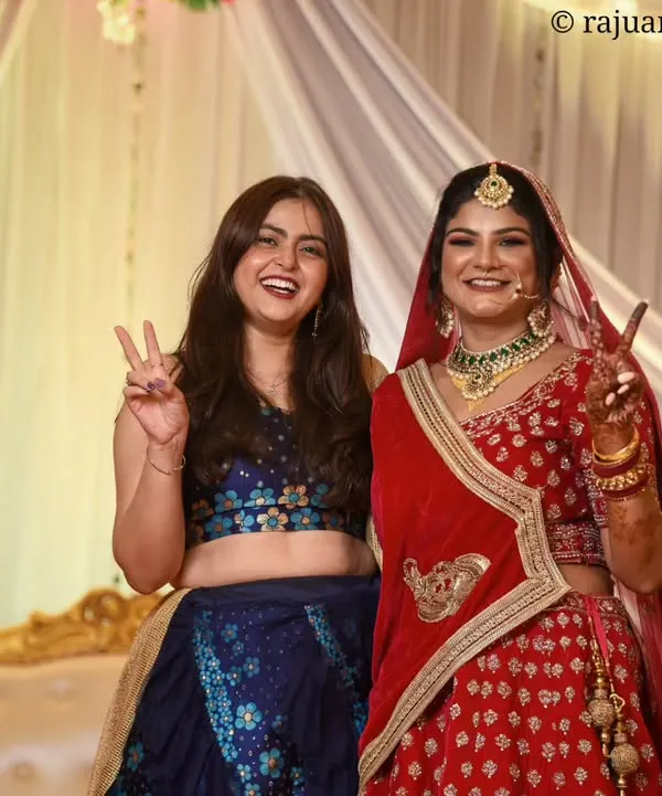 The bride sharing a moment of pure joy and fun with her bridesmaid. Capturing these candid interactions with friends and family is an essential part of the wedding story.