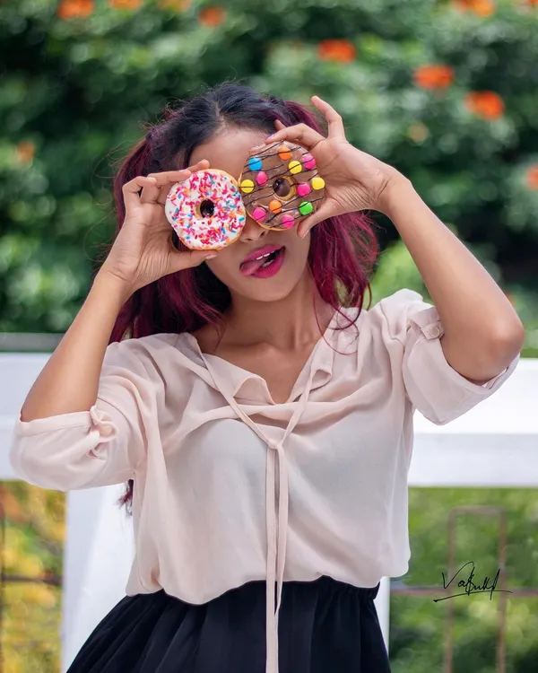 Peek-a-boo with donuts! This playful and colorful shot is from a fun lifestyle session. Using props like these is a great way to bring out a model's personality and create joyful, authentic moments.
