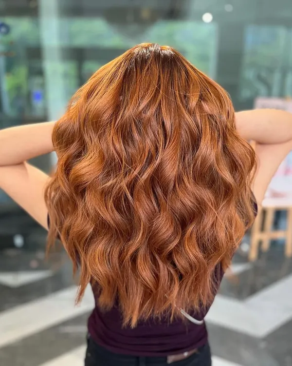 A vibrant copper balayage that is fiery and full of personality. This color is perfect for making a bold statement.