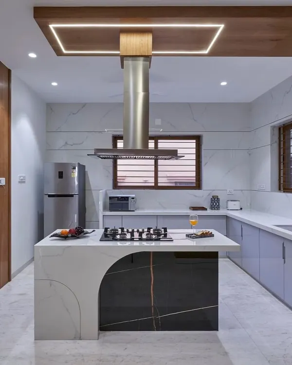 This kitchen is the heart of the home, designed for both serious cooking and casual gatherings. The statement island with an integrated cooktop, marble finishes, and custom cabinetry combines high functionality with a sleek, modern aesthetic.