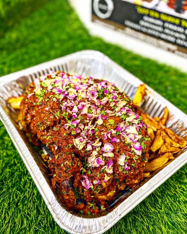 My showstopping Mutton Sikandari Raan. A whole leg of lamb is marinated for hours and slow-cooked until it's incredibly tender, then garnished with rose petals. It's a true centerpiece for any grand celebration.