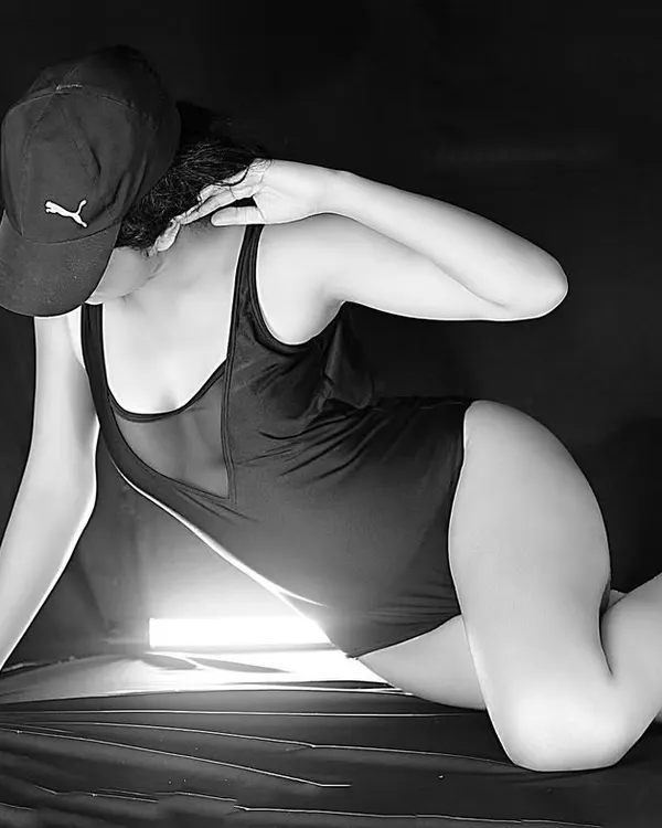 A bold, monochrome shot using a single light source to create a dramatic, high-contrast look. This is perfect for an edgy fitness or fashion portfolio.