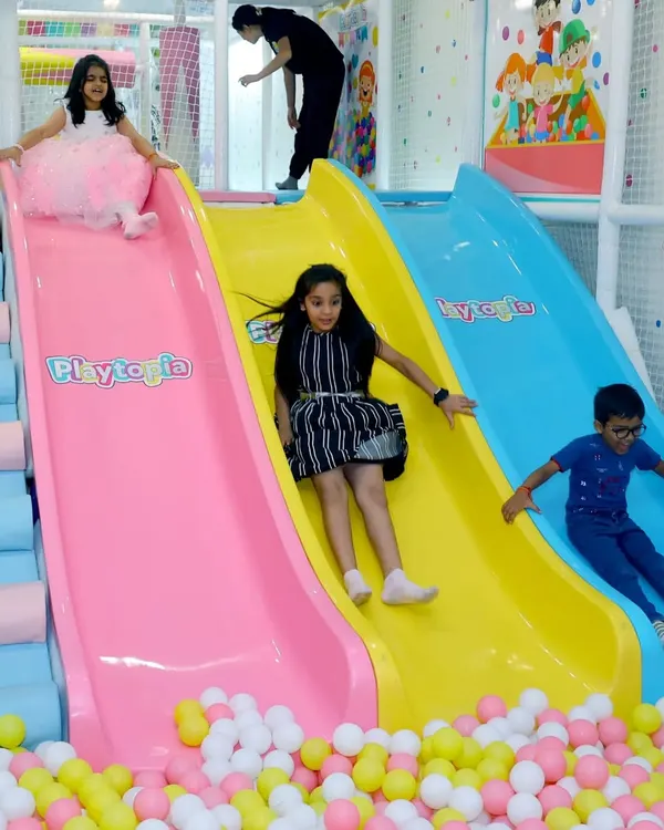 Welcome to a world of color and fun! I love seeing the pure joy on kids' faces as they race down our multi-lane slides and splash into a sea of soft play balls.