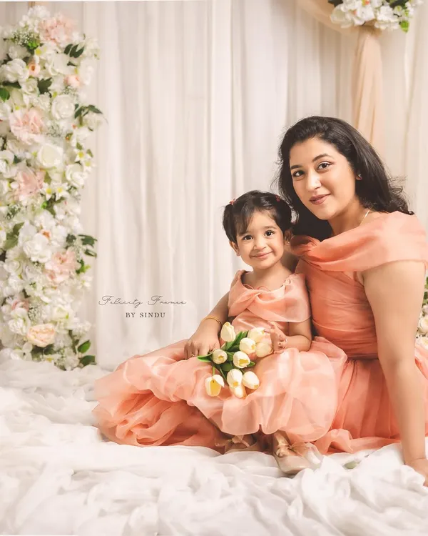 Creating memories stitched with love. This enchanting mother-daughter duo, Meghana and her little one, are twinning in elegant peach organza gowns I designed for their special Mother's Day photoshoot.
