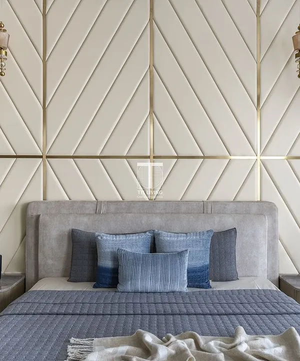 We designed this bedroom with a striking upholstered wall panel in a chevron pattern. The custom bed and floating bedside tables were crafted to create a cohesive and luxurious look, with every detail adding to the room's modern elegance.