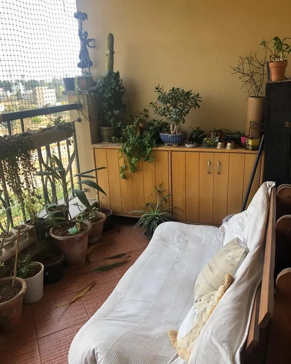 This was the 'before' shot. The balcony had an unused sofa and a collection of plants that needed organizing. I saw the potential to repurpose the sofa's frame into something new and functional.