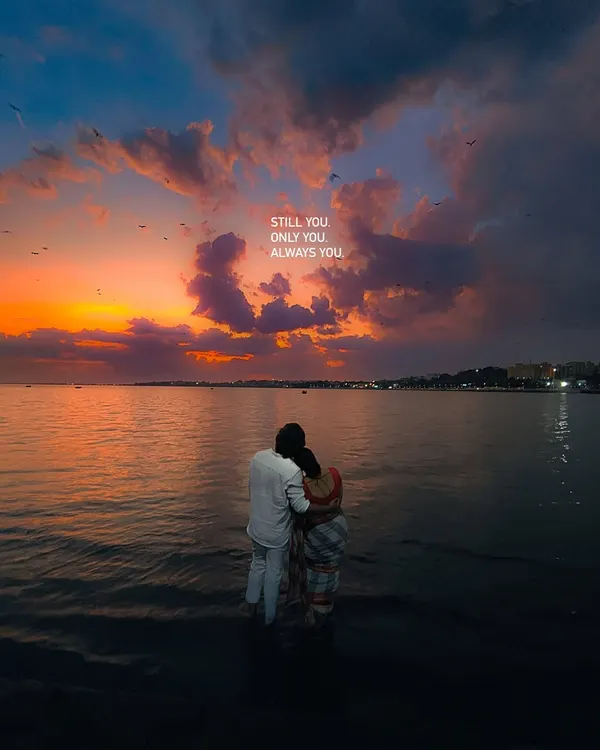 Still you, only you, always you. A romantic shot of a couple standing in the water at sunset, captured on an iPhone.