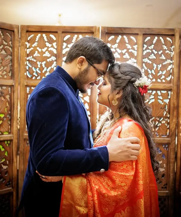An intimate moment between a couple after their court marriage, their foreheads touching in a gesture of love.