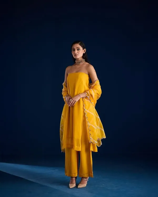 A stunning full-length shot for designer Aapro against a custom-painted deep blue cyclorama. This demonstrates how we can create a specific mood to match a collection's color palette.