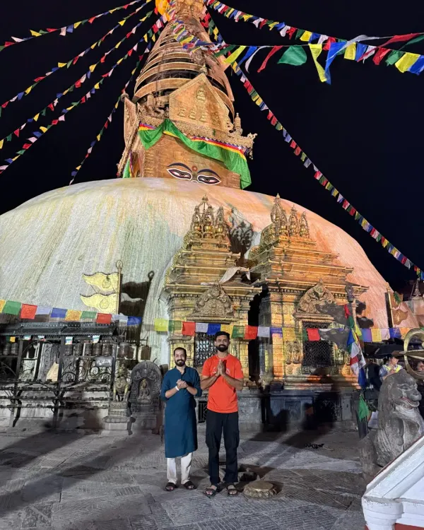 In the quiet of the night, we stand in reverence before the great Bouddhanath Stupa in Nepal. The air is thick with prayer, and the eyes of the Buddha watch over us as we offer our gratitude.