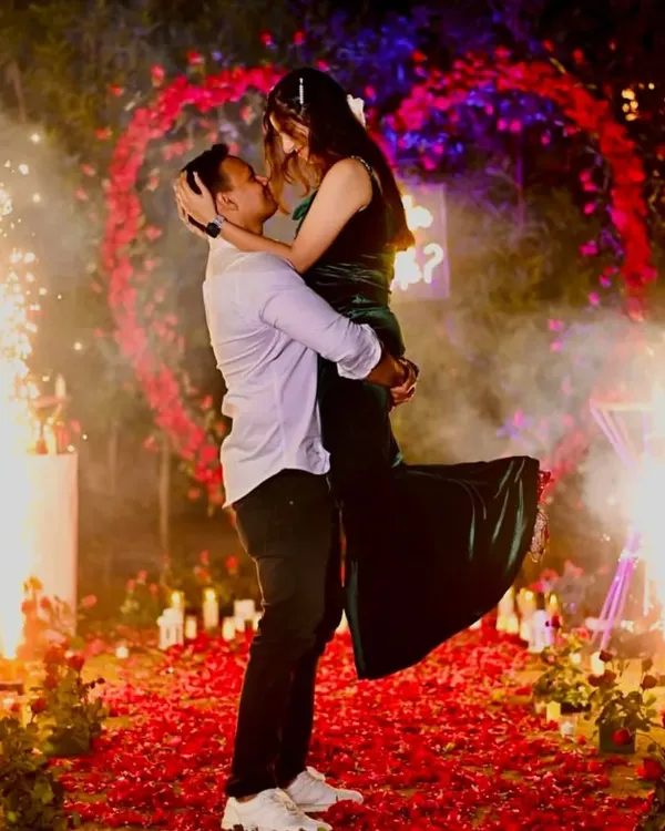 A picture-perfect moment right after she said yes! This romantic proposal setup included a heart-shaped floral arch, a candlelit path, and even cold pyro sparklers for that extra dramatic effect.