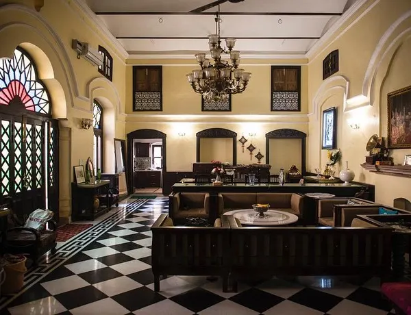 The main hall of a 19th-century haveli in Old Delhi after restoration. We revived the space as a contemporary home, restoring the original checkerboard flooring, intricate door arches, and installing a period-appropriate chandelier to bring back its former grandeur.