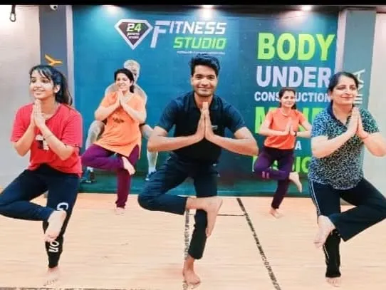 Leading a group of enthusiastic students in Vrikshasana (Tree Pose) at 24 Fitness Studio in Malviya Nagar, Delhi. The collective energy helps everyone stay motivated.