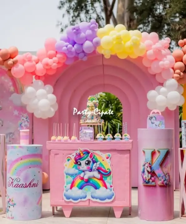 Kashni's unicorn party was a pastel dream. The main stage featured a large pink rainbow backdrop, adorable unicorn cutouts, and a beautiful balloon arch.
