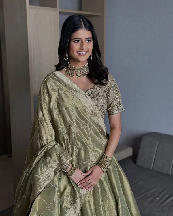 Bridal glam that listens, understands, and delivers. For her engagement, we chose a minimal look with glowing skin and soft definition to complement her elegant olive green lehenga.