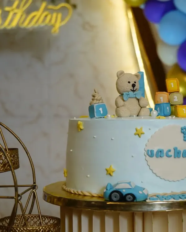 A close-up of a teddy bear-themed cake for a first birthday, showing the intricate details.