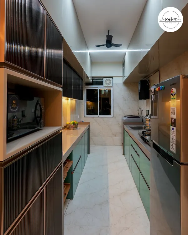 A sleek parallel kitchen design in a striking teal and grey combination. We used fluted glass for the overhead cabinets and integrated lighting to create a high-end, modern look.