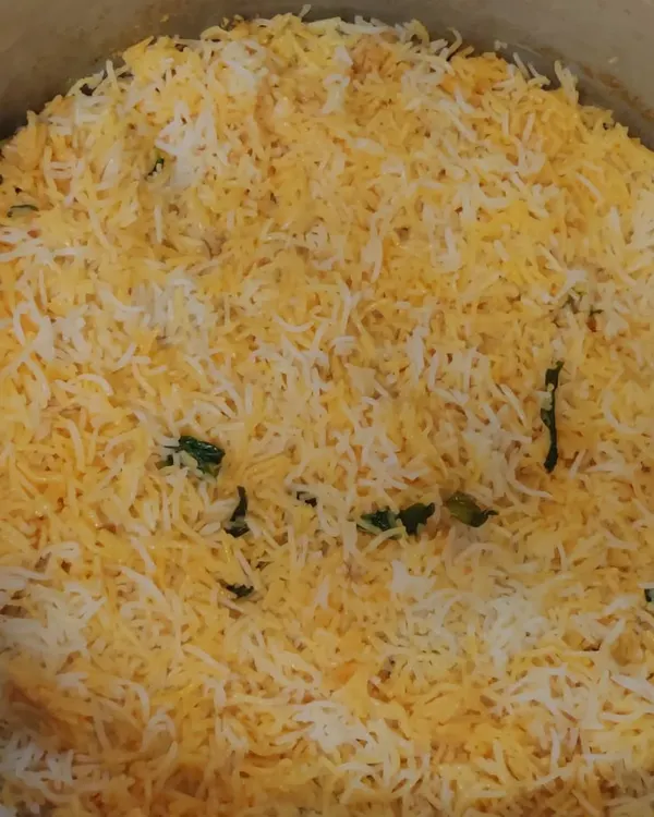A large pot of our authentic Muslim-style biryani, cooked over firewood. The long-grain basmati rice and tender meat are layered and slow-cooked to perfection.