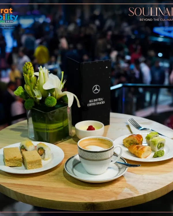 A sophisticated spread of coffee and gourmet snacks at the Mercedes-Benz pavilion during the Bharat Mobility Global Expo. We provide premium hospitality that aligns with the world's leading luxury brands.