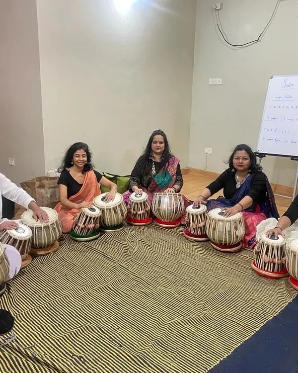 We believe music is for everyone. Here, our adult students are deeply engaged in a group tabla class, demonstrating that it is never too late to learn a new skill and find your rhythm.