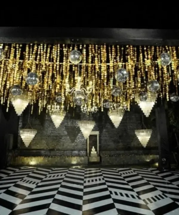 A sangeet night dripping in glitz and glam. We designed a stunning ceiling of cascading golden strings and disco balls, with a geometric black and white dance floor below.