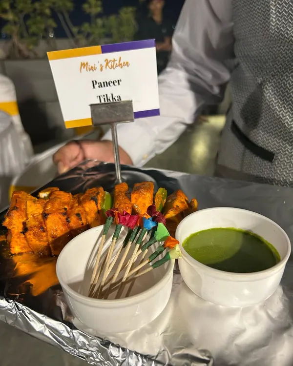 Here is my delicious Paneer Tikka being served at a terrace party. The paneer is marinated in spices and grilled until tender, served with a fresh mint chutney. This is a classic appetizer that I guarantee your guests will love.