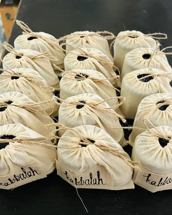 Preparing a corporate gift order. These full-sized body creams and polishers are packed in reusable muslin bags, making a thoughtful and sustainable gift for any team.