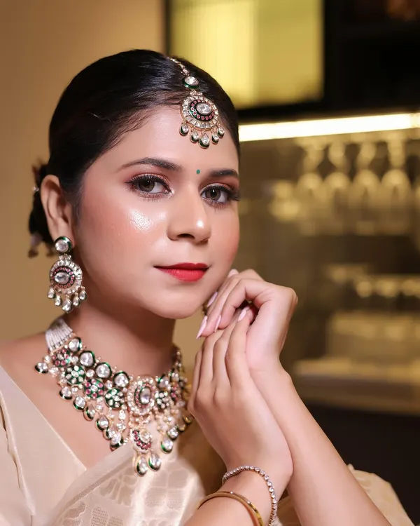 A complete bridal look featuring one of our premium Moissanite and Meenakari necklace sets. This shows how our jewellery provides a luxurious, high-end feel, making it a perfect centerpiece for any bridal collection.