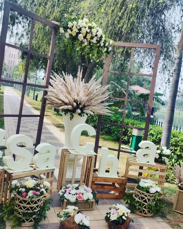A personalized welcome setup featuring the couple's wedding hashtag. I used rustic wooden crates, pampas grass, and fresh flower baskets to create a trendy and welcoming decor piece.