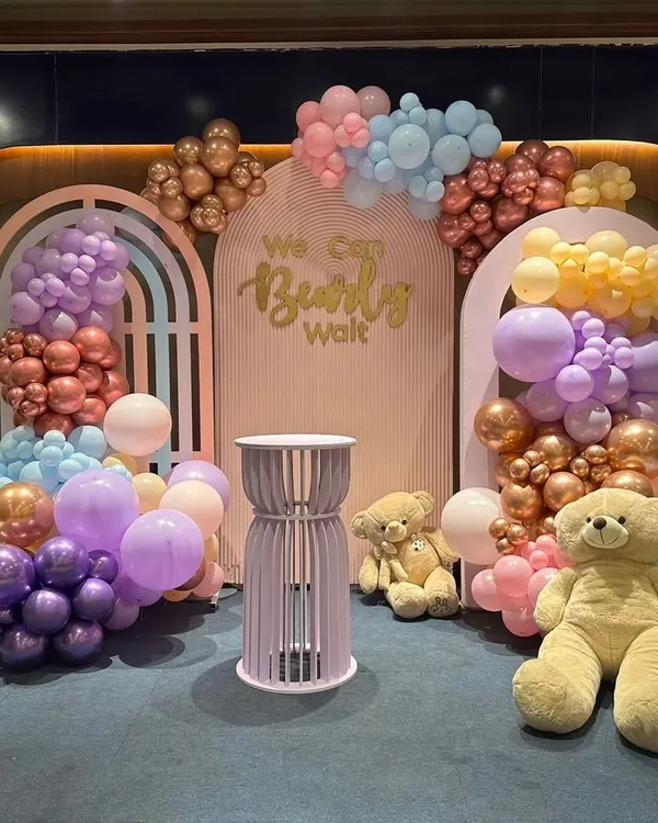 A beautiful 'We Can Bearly Wait' themed baby shower. I used a soft pastel balloon arrangement with multiple shades, custom arched backdrops, and cute teddy bear props to create this adorable setting.