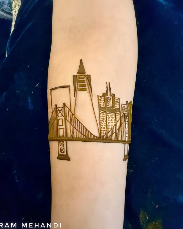 The start of a custom San Francisco skyline design. This is the initial outline of the Golden Gate Bridge and city buildings on the forearm.