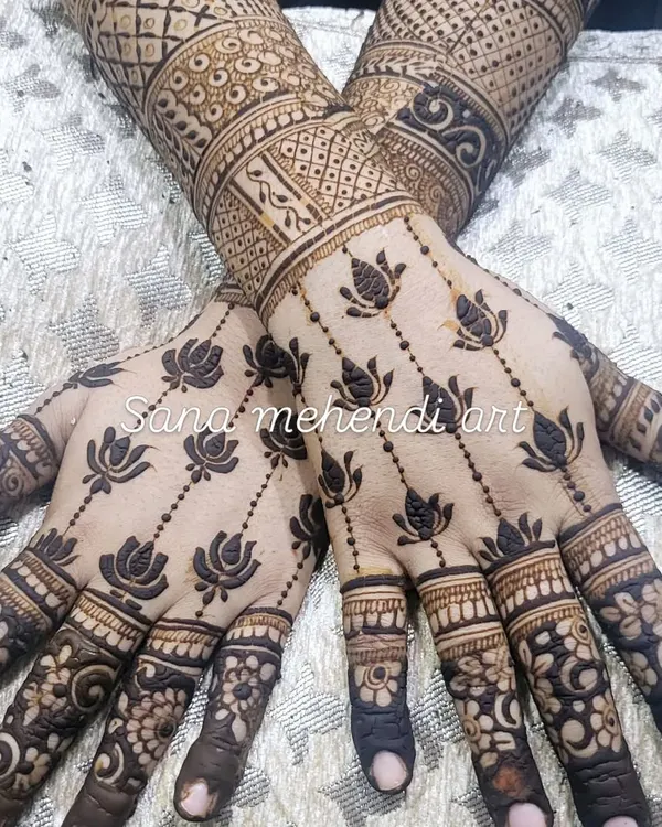 A very popular and elegant design for the back of the hands. This pattern features delicate lotus flowers connected in hanging chains, with more intricate work on the forearms.