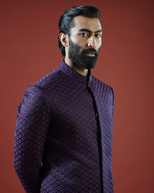 A deep purple Bandhgala jacket featuring a subtle, geometric texture. This piece is a prime example of modern sophistication, perfect for a cocktail evening or reception, offering a look that is both commanding and refined.
