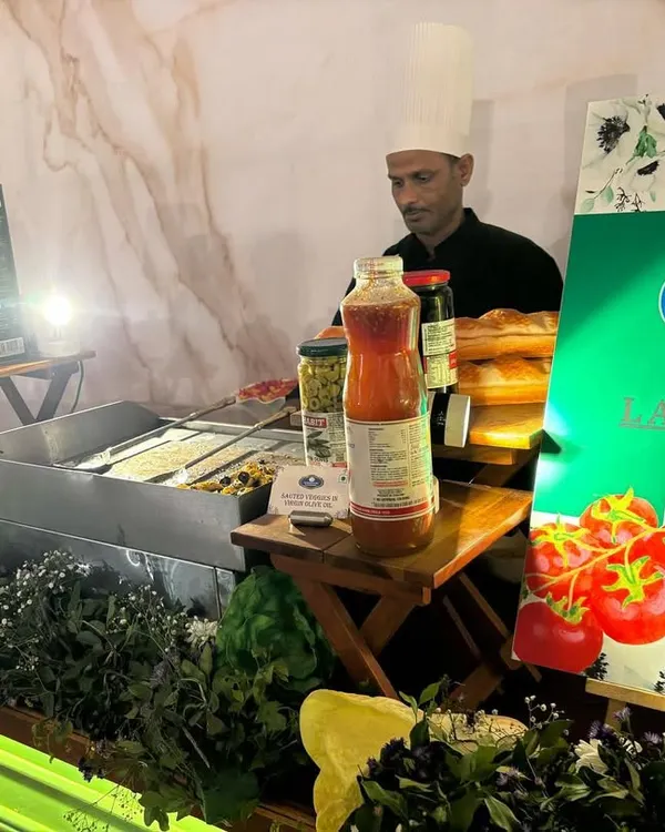 Our chef at the 'La Italia' station, preparing for a busy service. The counter is stocked with authentic ingredients, showcasing our readiness to serve fresh, made-to-order Italian food at a wedding.