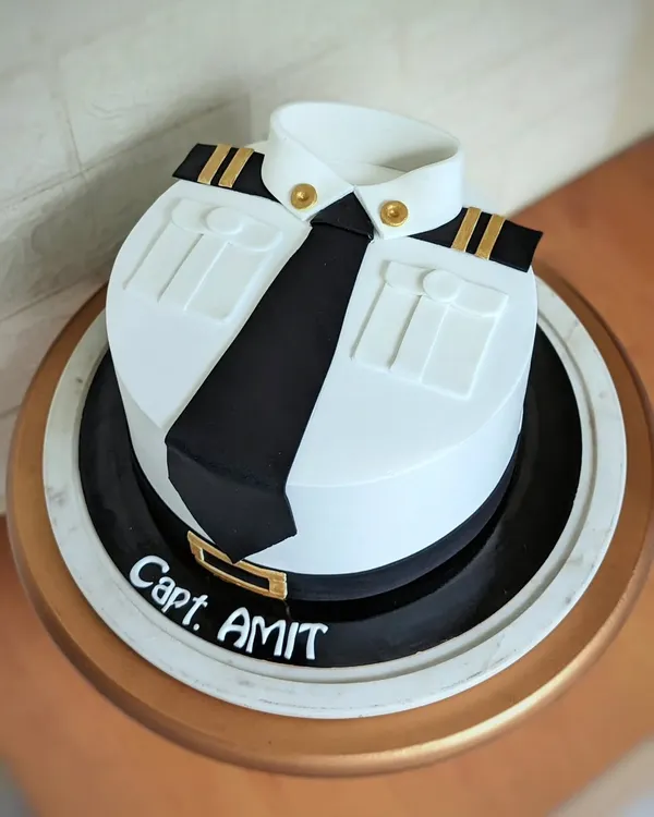 Let your dreams take flight! This pilot uniform cake is all about clean lines and professional pride. The crisp white shirt, black tie, and detailed epaulets are all handcrafted from fondant for a sharp, impressive finish.