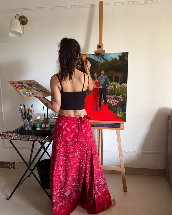 A view from behind the easel as I work on a custom couple's portrait. Using oil paints, I carefully build up the details of the figures and the lush garden background to create a piece they'll cherish.