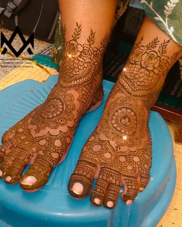 A classic bridal foot mehendi design, with a central mandala and detailed patterns covering the entire foot and toes.