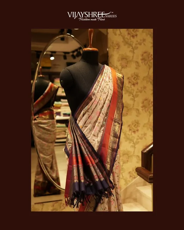 A soft drape Fusion Kanjivaram graced with intricate floral hand embroidery. This piece is a perfect example of how we blend modern aesthetics with traditional weaving techniques.