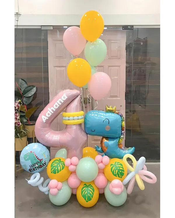 A roar-some dinosaur bouquet for Aahana's 4th birthday. This cute and colorful arrangement features a friendly T-rex, a personalized number balloon, and tropical leaf details for a prehistoric party vibe.