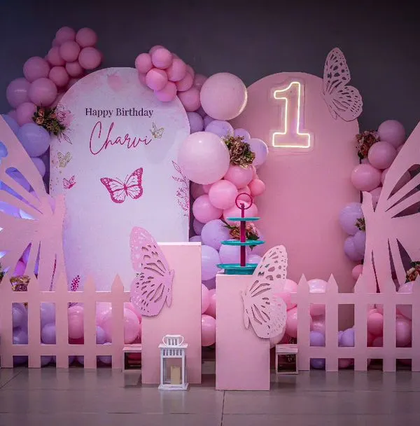 A brand new butterfly theme setup, designed in shades of pink with large, elegant wing cutouts and a custom neon sign. I create a fresh moodboard for every celebration to ensure your party is unique.
