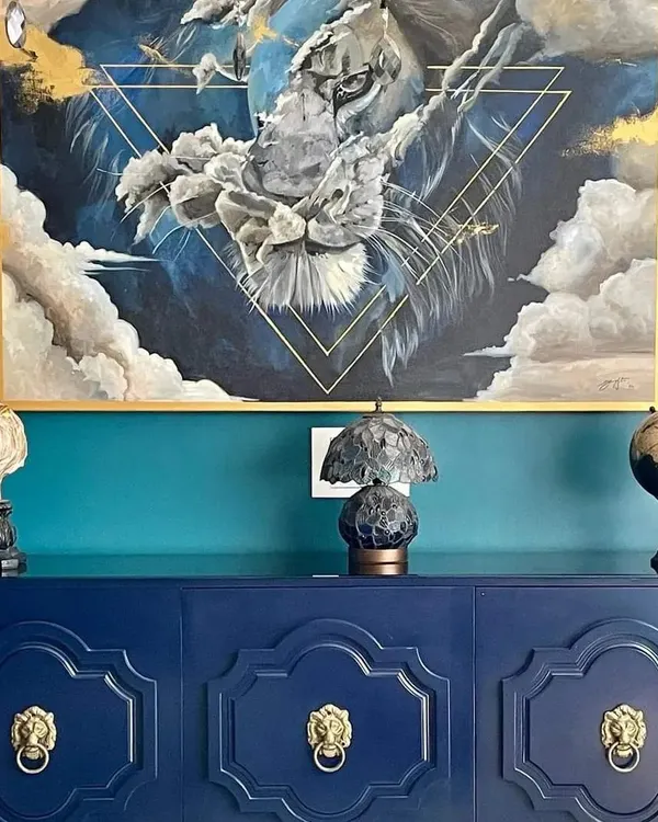 This commissioned acrylic painting captures the powerful yet serene energy of a lion. I used a combination of deep blues and metallic gold accents to create a piece that feels both majestic and integrated into the client's beautiful home decor.