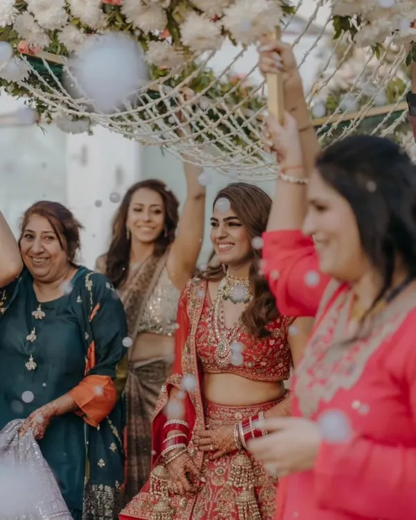 The real bridal glow begins with mehendi. This bride's radiant smile during her entrance, with her hands adorned in henna, captures the love, patience, and tradition that make a wedding so beautiful.