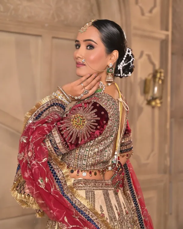 This view highlights the intricate details of the blouse and the elegant bridal hairstyle. The makeup is kept sophisticated to balance the grandeur of the entire ensemble.