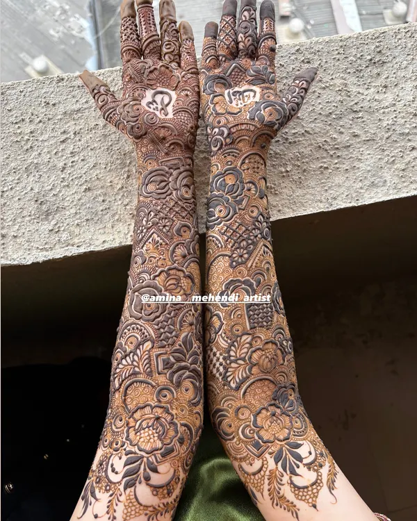 A full-coverage bridal design shown in natural light, highlighting the contrast and detail. The pattern combines geometric fills with soft, shaded floral work.