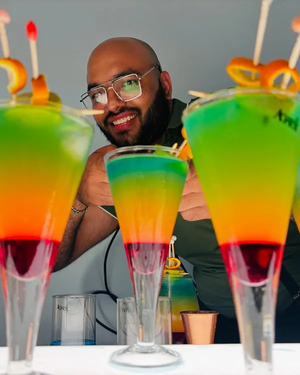 A lineup of our vibrant, multi-layered 'Rollercoaster' cocktails, ready to bring a splash of color and fun to your party. This is what a 'drinkgasm' looks like, and it's the perfect centerpiece for any celebration.