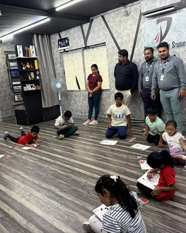 A behind the scenes look at our kids' coloring competition. Campers are spread out on the studio floor, completely absorbed in their artwork.