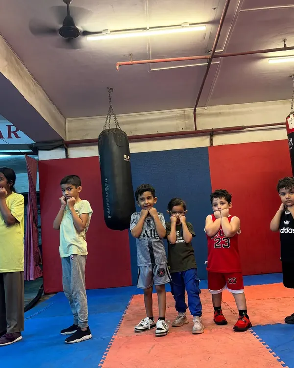 The future of boxing starts here. A group of our young students stands ready, learning the basic defensive guard position. I teach them the importance of a solid foundation from day one.