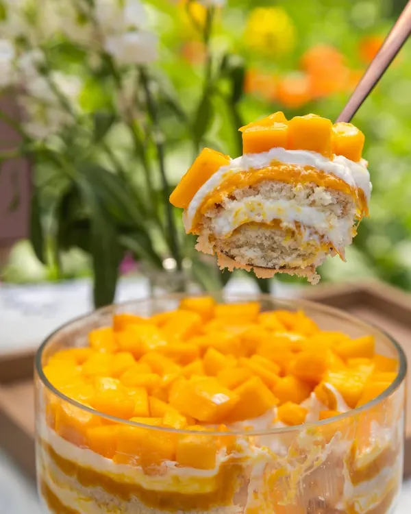 A spoonful of summer. This is my Mango Cream Cheese Trifle, showing the layers of soft cake, light cream cheese, and sweet, fresh mango.