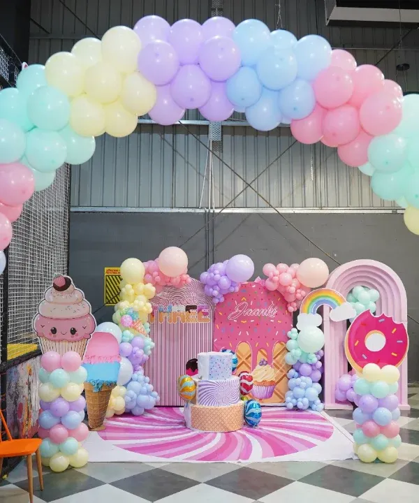 Welcome to a candy-themed dreamland! This stunning setup with pastel balloon arches and giant ice cream props shows how we transform our space for a truly sweet and memorable birthday celebration.