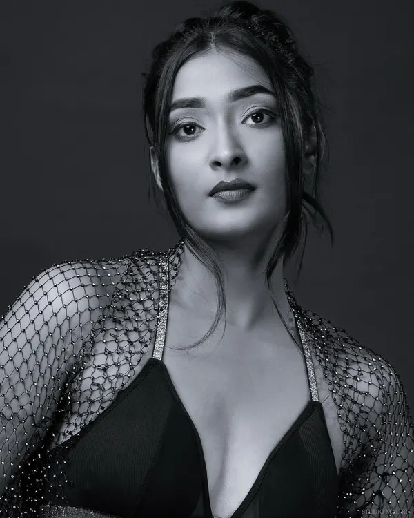 A classic black and white headshot with a direct, engaging gaze. This monochrome portrait is perfect for a model's portfolio, emphasizing natural features and expression.